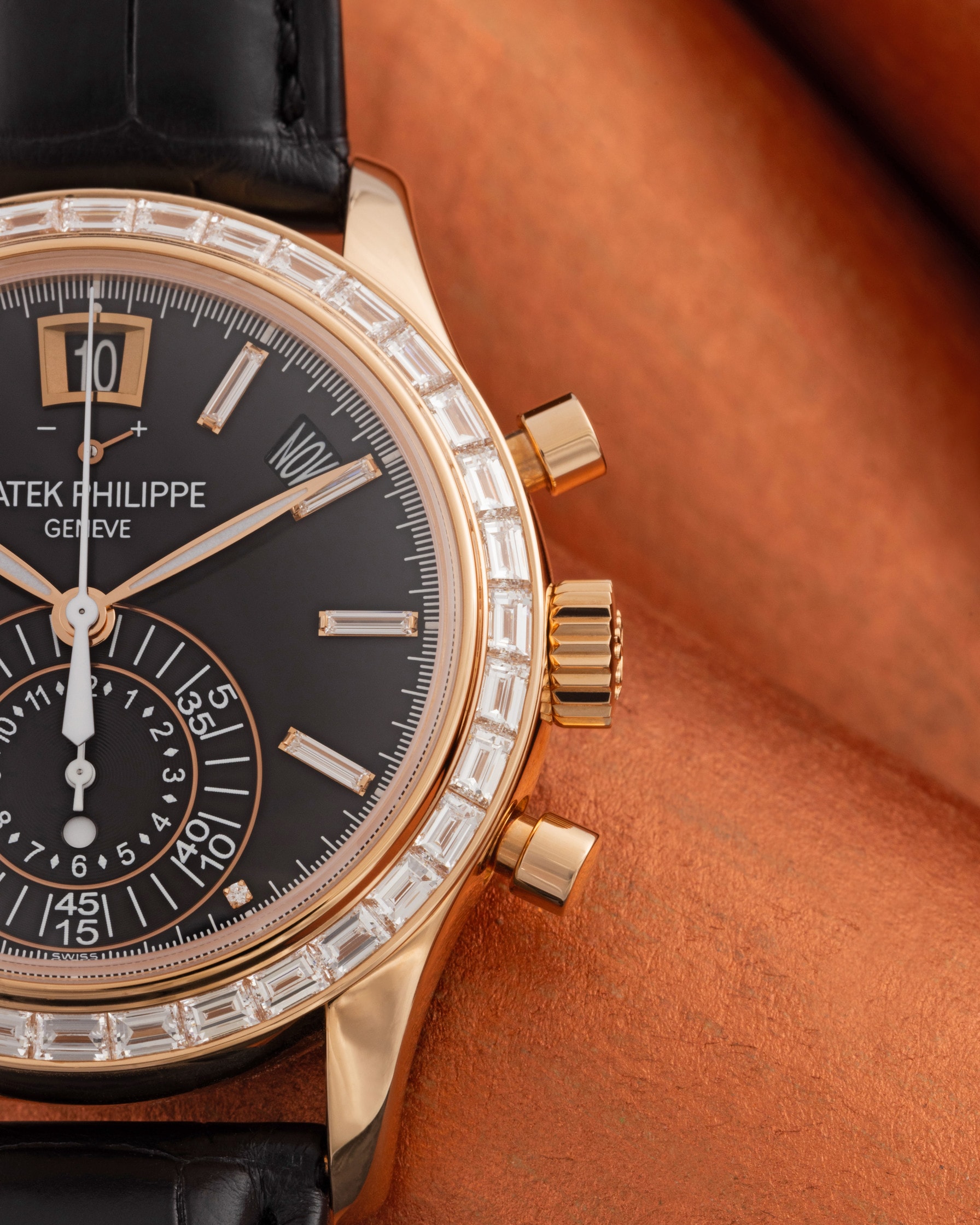 Patek Philippe annual calendar chronograph in rose gold with a baguette bezel, close-up